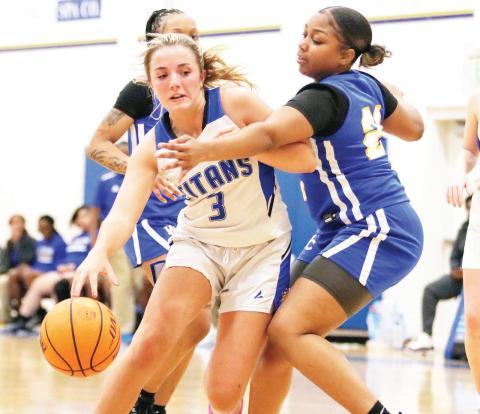 Lake Oconee Academy senior Georgia Bosart (3) drives the lane between two Warren County defenders in an attempt to score. LANCE McCURLEY/Staff