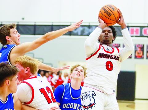 Morgan County senior Ryan Moore (0) attempts a jump shot in a win over Oconee County on Nov. 16. LANCE McCURLEY/Staff