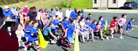 With many wearing “Seuss on the Loose” t-shirts, runners explode off the start of a recent Seuss Fun Run at Putnam County Primary School. CONTRIBUTED
