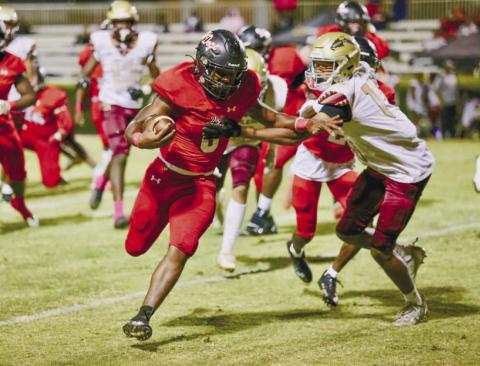 Morgan County senior D.J. Smith (6) tries to stiff-arm a Salem defender on his way to the end zone. JIM TURNER/Contributed