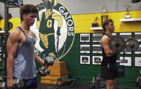 Gatewood’s Colt Jenkins (left) and Landon Moreno hit the weights in preparation for the upcoming football season. IAN TOCHER/Staff