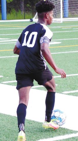 Senior midfielder Kyle Beasley looking to play the ball forward to his teammates in the first round of the GHSA State Playoffs against Armuchee High School. BRENDAN KOERNER/Staff