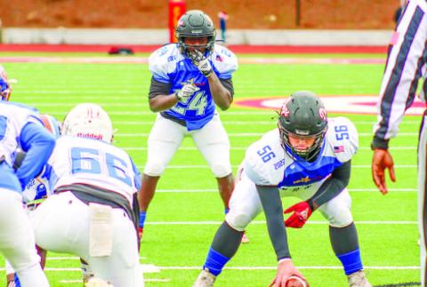 Morgan County center Griffin Britt (55) gets set to snap the ball to Bulldogs’ running back Jacere Cooper (24), who is in the wildcat formation for the Blue Team. LANCE McCURLEY/Staff
