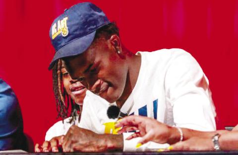 Brown signs his letter of intent to play college basketball at North Carolina AT&amp;T. The Bulldog senior held his signing ceremony last Wednesday at Morgan County High School’s auditorium. Brown was surrounded by friends, coaches and family. LANCE McCURLEY/Staff