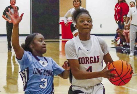 Morgan County sophomore Kymora Smith (4) beats Long County guard Makinzie Moody (3) in transition for a layup. LANCE McCURLEY/Staff
