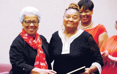 Mothers Against Crime member Brenda Bonner (right), who has been volunteering with the organization since its 1992 inception, received a special service award Saturday night from MAC founder and organizer Georgia Benjamin-Smith. IAN TOCHER/Staff
