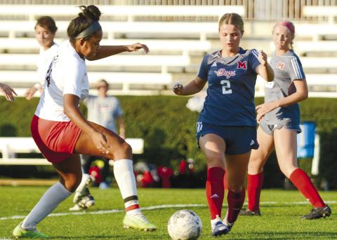 Junior Lofton Cathey (2) tries to keep the ball away from a Clarke Central defender in Morgan County’s 3-0 win over the Lady Gladiators last week. LANCE McCURLEY/Staff