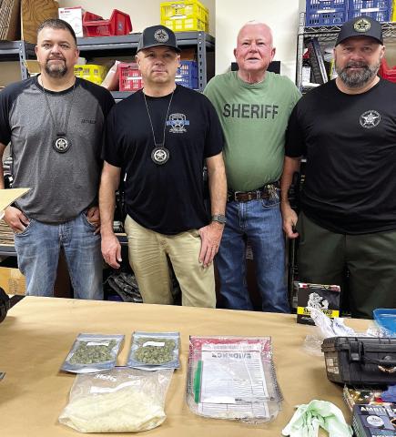 Morgan County Sheriff’s Investigators Sgt. Chase Young, Chad Lanier and Joseph Pritchett, and Putnam County Sheriff’s Investigator Lt. Harry Luke (in green shirt) show the drugs they worked to get off the streets. CONTRIBUTED