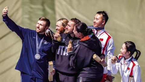 Former Eatonton resident Vincent Hancock (left) takes a selfie on the Olympic podium in France alongside his silver medalist partner Austen Smith (second from left) and the gold and bronze medal-winning pairs from Italy and China, respectively, in mixed team skeet shooting. Courtesy USA Shooting