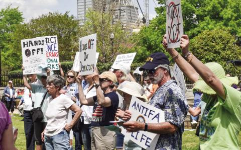 Protest signs share messages about the Trump administration during the Hands Off! event in Madison. T. MICHAEL STONE/Staff
