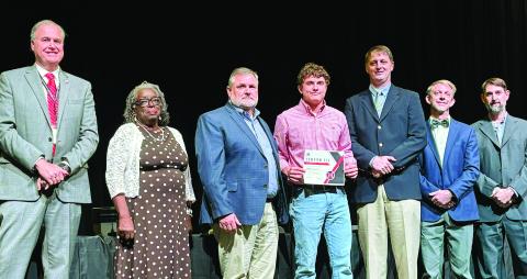 Morgan County High School student Mason Nunn (center) is recognized by the Morgan County Board of Education Nov. 11 for being the National FFA winner in grain production proficiency. HANNAH BARRON/Staff