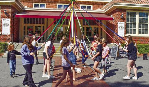 Attendees participate in the Maypole Dance under the guidance of Helen Garcia-Carreras, the choreographer at The Arts Barn. According to her, the maypole dance is a German tradition celebrating the revival of nature. Her mother, Lora Garcia-Carreras, owner of The Arts Barn, studied dances of various countries and was inspired by this German tradition. LENA HENSLEY/Staff