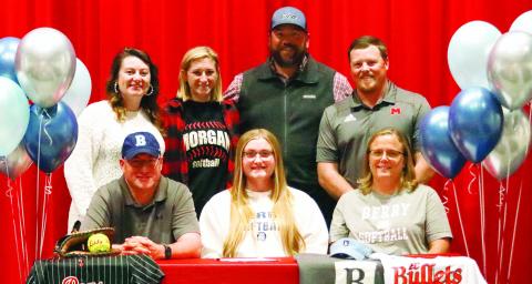 Ryan Henderson (first row, center) with her parents and the Morgan County softball coaching staff. LANCE McCURLEY/Staff