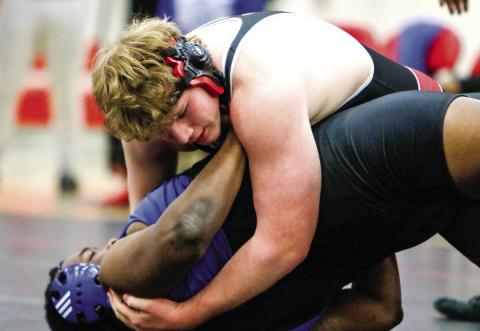Morgan County’s Clay Turner tries to pin his opponent from Burke County at the area team duals tournament in Madison on Monday, Jan. 13. LANCE McCURLEY/ Staff