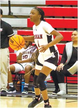 Sophomore Kymora Smith (4) handles the ball at the top of the key against ARC on Tuesday. LANCE McCURLEY/Staff