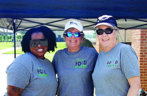 L-R: Greene County Food Pantry employee Daisy Bell, board member Becky Smith, and volunteer Mary Kay Landsberg represent the Pantry at the Summer Harvest Food Distribution at GCHS. CONTRIBUTED