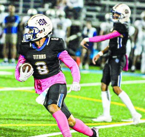 Titan senior Cameron Kelley (8) runs the ball outside the tackles in last week’s contest against Augusta Prep Day. CHARLES JORDAN/Staff