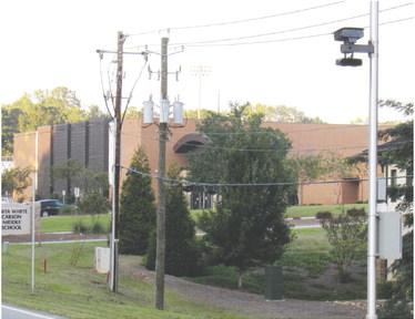 Cameras mounted along Main Street (upper right in photo) to catch speeders in front of the middle and high schools will be activated soon. MARK ENGEL/Staff