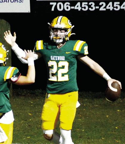 Gatewood senior Hunter Johnson (22) celebrates his second touchdown of the opening quarter Friday night with sophomore teammate Drew Love in what turned out to be a 48-8 win over the visiting Thomas Jefferson Jaguars. IAN TOCHER/Staff