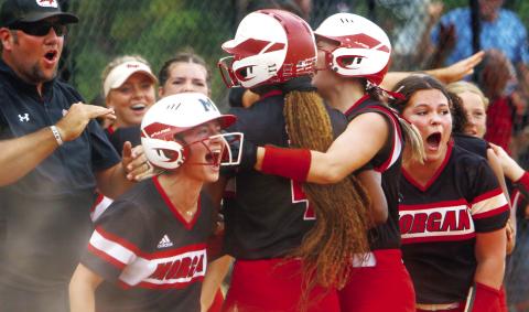 The Morgan County softball celebrates a huge victory after Kymora Smith (4) scored the game-winning run on a passed ball against Rockmart last Wednesday in the opening round of the Class AA Elite Eight tournament in Columbus. LANCE McCURLEY/Staff