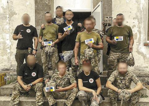 Paramedics in Ukraine (with faces blurred to provide anonymity) pose with medical supplies sent by Lake Country Medical Aid for Ukraine (LCMAU). CONTRIBUTED