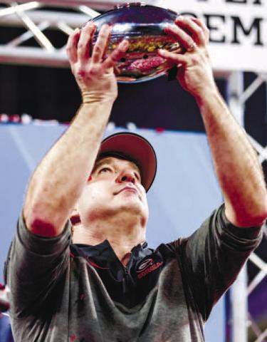 Georgia head football coach Kirby Smart displays the Peach Bowl trophy after the Bulldogs secured their trip to Los Angeles to face TCU. TONY WALSH/UGA Athletics