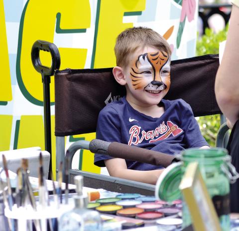 This young Braves fan is delighted with his new look. T. MICHAEL STONE/Staff