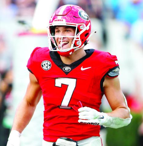 Georgia tight end Lawson Luckie runs off the field with a smile after catching his third touchdown pass of the game. LANCE McCURLEY/Staff