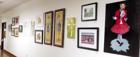 A variety of artwork hangs on the wall at Festival Hall in Greensboro and will remain on display for the next nine months. LEIGH LOFGREN/Staff