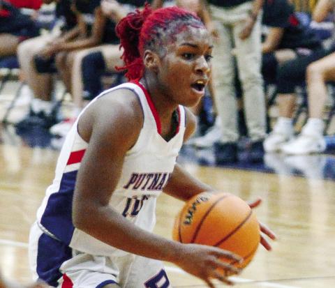 Putnam County junior Journey Waller (10) dribbles the ball through traffic in an effort to try and score during a rivalry game against Morgan County on Dec. 14. IAN TOCHER/Staff