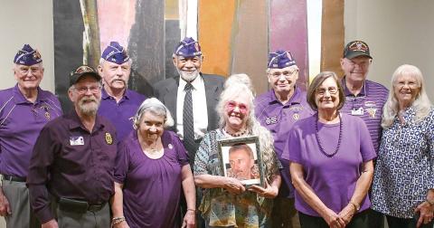 Members of the Athens-based John W. Hancock Memorial Chapter 531 of the Military Order of the Purple Heart pose with the daughter of Charlie Bonner Award for Advancing Education winner Richard “Ole” Olsen, holding a photo of her father. IAN TOCHER/Staff