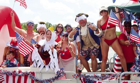 The Massey family and their friends celebrate winning the prize for the most decorated boat at last year’s boat parade. LANCE McCURLEY/Staff
