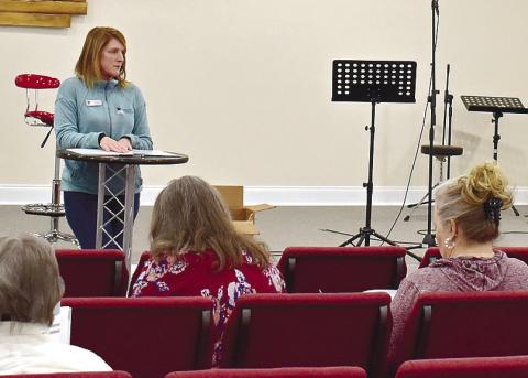 Jodi York of Families 4 Families explains to the audience at Crossroads Baptist Church what requirements exist to become foster parents in Georgia. LENA HENSLEY/Staff