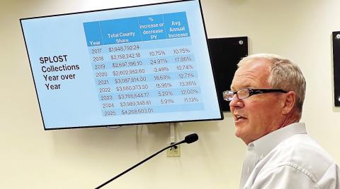 Putnam County Manager Paul Van Haute addresses local politicians on Monday, describing the history and potential of a local SPLOST. IAN TOCHER/Staff