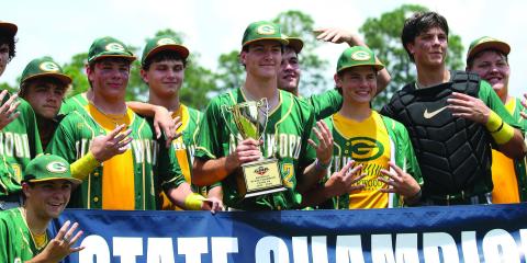 Gatewood players pose with their fourth consecutive state championship trophy last Friday in Statesboro. TREY NORRIS/Staff