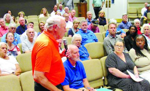 Greene County Commissioner Ernie Filice (standing) asks a question during Tuesday’s town hall meeting held by Congressman Mike Collins (R-Ga 10th) in Greensboro. MARK ENGEL/Staff