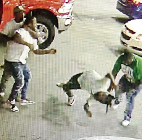 Antwan Barnes, wearing the green shirt, attacks Keon Lewis at the Jet No. 44 last month. Barnes was arrested last week. CONTRIBUTED/ EPD