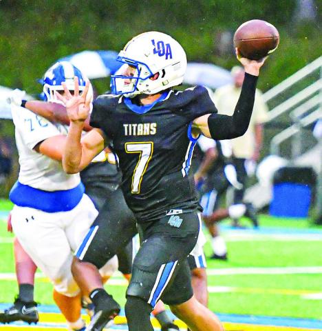 Lake Oconee quarterback Ike O’Neal (7) tries to attempt to complete a pass to a teammate in a game earlier this season against Brentwood Academy. CHARLES JORDAN/Staff