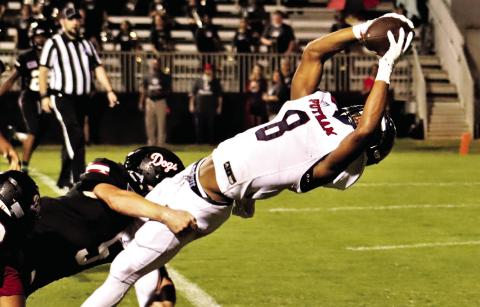 Cedrion Brundage bends over backwards to break the goal line plane and score Putnam County’s first touchdown of the 2021 season against the Morgan County Bulldogs, leading to a 37-0 rout. ARELLA CASH/File photo