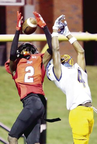 Morgan County senior wide receiver Jaylen Elder (2) hauls in a pass over Warren County defender Cosa Pender (4). JIM TURNER/Contributed