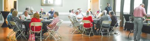 Volunteers enjoy a free meal together, hosted by The Plaza Arts Center, as thanks for their time and dedication to the center. BAILEY BALLARD/Staff