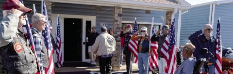 The Honor Flag line supports the wounded veterans as they arrive at the Elks Lodge. LEIGH LOFGREN/Staff