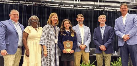 L-R: Morgan County Board of Education members Joe Slaughter, Cheryl Bland, Dr. Susan Stancil, Brad Hawk, Dr. Forest Pagett, and Andrew Ainslie III recognized MCMS eighth grader Hailey Boyd, who was named recently FFA state winner for Middle School Horticulture. SKYLA MORRIS/Staff