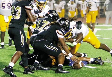 Greene County’s Amari Durham recovers a fumble late in last week’s game against Warren County, helping seal the win for the Tigers. LANCE McCURLEY/ Staff