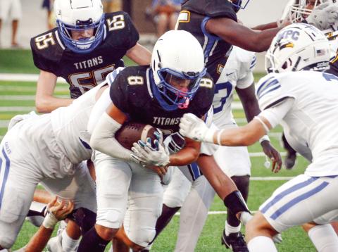 LOA running back Cameron Kelley (8) fights his way through Mount Paran defenders. IAN TOCHER/Staff