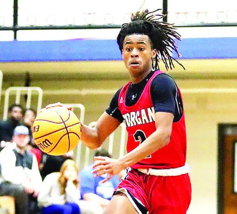 Morgan County sophmore guard Jacoby Simmons (2) drives the lane inside during the first quarter against Oconee County on Tuesday night. LANCE McCURLEY/Staff