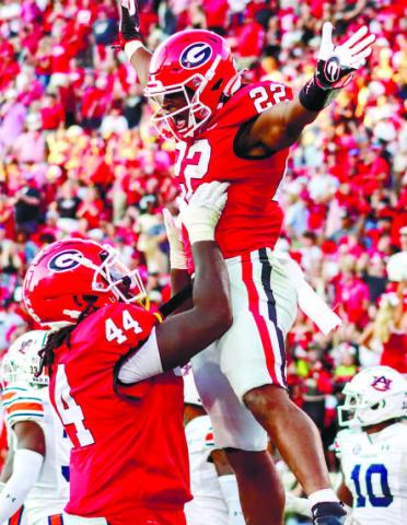 Georgia freshman running back Branson Robinson (22) got his first touchdown in Sanford Stadium Saturday against the Auburn Tigers. He was also the leading rusher in the game. LANCE McCURLEY/Staff