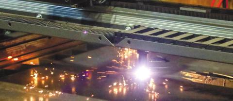 The CNC plasma cutter grinds away at a one-inch thick sheet of metal. Kernic was cutting out a design of a large mouth bass for an upcoming project.