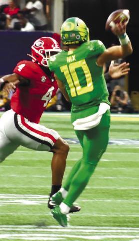 Senior linebacker Nolan Smith (4) chases after Ducks’ quarterback Bo Nix (10) as he scrambles out of the pocket and toward the right sideline. BRENDAN KOERNER/Staff