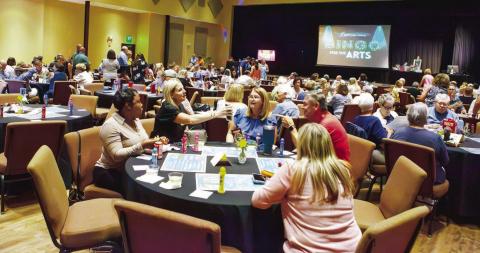 Participants are deep in concentration on the bingo cards as each number is announced. (LEIGH LOFGREN/Staff)